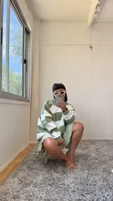 Buzo de corte oversize con diseño de rayas horizontales anchas en color verde y crudo. Presenta cuello redondo, mangas largas y puños elásticos, confeccionado en tela con interior de felpa.