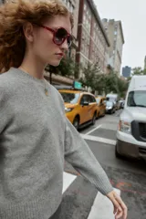 Jersey de punto color vino tinto, de cuello redondo y manga larga, con acabado acanalado (rib) en puños, cuello y bajo.