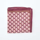 Pañuelo cuadrado de tela color borgoña con estampado floral en tonos rosa y beige.