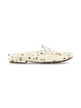Zueco destalonado tipo mocasín confeccionado en cuero con pelo con estampado animal print tipo vaca en tonos blancos, marrones y negros.