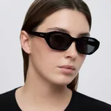 Lentes de sol con montura heptagonal de diseño angular y estilo oversize, en color negro total con lentes polarizadas.