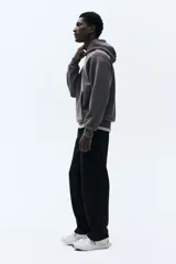 Pantalón de jogging negro de punto pesado, corte recto y calce estándar. Posee cintura elástica con cordón ajustable y bolsillos laterales insertados.