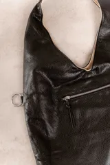 Bolso de hombro color beige, confeccionado en cuero sintético con interior plateado. Presenta un bolsillo externo con cierre.