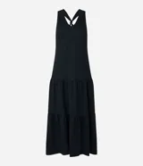 Vestido midi de corte evasé confeccionado en tejido piquet color negro. Presenta un diseño sin mangas con escote en V, breteles anchos cruzados en la espalda con detalle de nudo y falda con recortes de volados en la parte inferior.