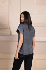 Remera gris con efecto gastado, cuello redondo y mangas cortas con dobladillo. Estampado frontal de un rostro de leopardo en blanco y negro con un rayo rosa y amarillo.