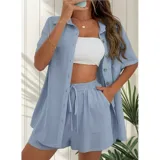 Conjunto de dos piezas color azul claro, compuesto por una camisa de manga corta con cuello italiano y cierre frontal de botones, y un short de tiro alto con cintura elástica y cordón ajustable.