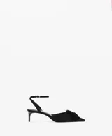 Zapato de tacón kitten color negro, con punta fina, tira ajustable al tobillo con hebilla y detalle de aplicación floral con flecos en el empeine.