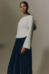 Top manga larga beige de interlock pesado con hombros caídos, escote redondo, pinzas moldeadoras en la cintura y bajo acampanado.