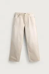 Jeans baggy fit confeccionados en denim de algodón color beige, de corte holgado y amplio en toda la pierna, con tiro medio y diseño de cinco bolsillos.