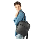 Mochila negra de cuero texturado con bolsillo frontal y asa superior.