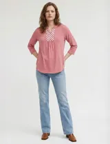 Blusa de manga tres cuartos color rosado, confeccionada en modal texturizado. Presenta un escote en V con cuello a la base y apliques nacarados en el área del escote.