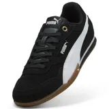 Championes Puma Bella Donna SD color negro con franja lateral blanca y suela de goma color caramelo.
