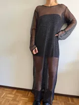 Vestido largo de red color negro con brillo plateado, de corte recto y mangas largas.
