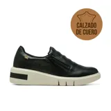 Championes deportivos casuales de cuero negro con diseño slip-on, cierre lateral y suela de plataforma blanca con detalle en negro.