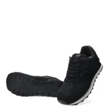 Championes urbanos New Balance modelo 574, color negro con textura de piel de serpiente en paneles laterales y puntera. Presenta el logo N característico en los laterales, entresuela blanca con motas negras y suela de goma.