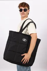 Bolso plateado acolchado con logo ovalado negro y blanco.