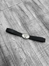 Cinto negro con hebilla plateada con forma de cráneo de toro.