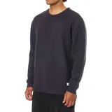 Buzo de punto de cuello redondo y manga larga, con puños y ruedo acanalados.