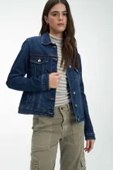 Campera de jean azul con cuello clásico, bolsillos frontales y cierre con botones metálicos.