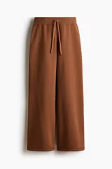 Pantalón deportivo de felpa con diseño acampanado, cintura elástica con cordón ajustable e interior cepillado suave.