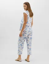 Pijama compuesto por remera sin mangas con escote redondo, botones frontales y detalle de puntilla, acompañado de un pantalón capri con cintura elástica. Presenta un estampado floral en tonos rosados sobre base gris.