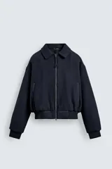 Cazadora de paño acolchada en su interior para hombre, de corte cropped y color azul marino. Cuenta con cuello solapa, mangas largas, bolsillos de doble vivo en la cadera, detalles de acabado en rib elástico en puños y cintura, y cierre frontal de cremallera metálica con doble carro.