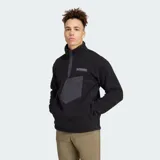Buzo de tela fleece gruesa Adidas Terrex de color negro, con cuello alto, cierre frontal parcial con botones a presión, bolsillo frontal con solapa y el logo de Terrex en el pecho.