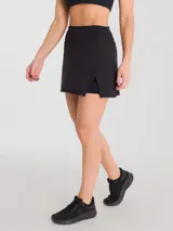 Falda deportiva negra con calza interior y bolsillo lateral. Diseño cruzado en la parte frontal.