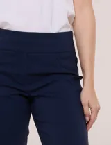 Pantalón capri azul marino de estilo sastrero, de tiro alto con pretina ancha y plana, corte entallado y bolsillos simulados en el frente.