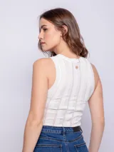 Musculosa fucsia de tejido de punto fino con cuello redondo y pequeños calados verticales.
