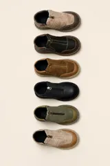 Botas cortas de cuero con suela cosida de 3 cm y cierre superior. Cuentan con dos elásticos al costado escondidos en el cuero para facilitar su uso y asegurar comodidad.