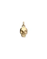 Dije de aleación de metales bañado en oro con forma de calavera.