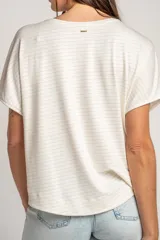 Remera de manga corta con calce oversize, color blanco con finas rayas horizontales plateadas, cuello redondo y diseño fluido.