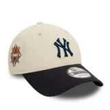Gorro New Era 9FORTY ajustable, color beige con visera negra, logo de los New York Yankees bordado en el frente y parche conmemorativo de la Serie Mundial en el lateral.