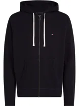 Buzo de felpa de algodón azul marino con capucha con cordón, cierre de cremallera, dos bolsillos delanteros tipo canguro y logo de Tommy Hilfiger bordado en el pecho.