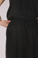 Pantalón palazzo de tiro alto color gris, con pinzas delanteras y bolsillos laterales.