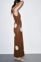 Vestido largo de punto marrón con cuello redondo y sin mangas, con estampado de lunares grandes en color crema.