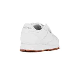 Championes Reebok Classic Leather blancos con suela de goma color caramelo y detalles en rojo.
