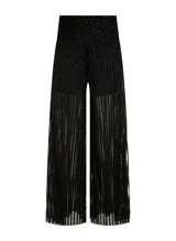 Pantalón de tiro alto con corte de pierna ancha y caída fluida. Confeccionado en tejido de punto con textura brillante y sutil transparencia, presenta una cinturilla ancha estructurada con un ligero fruncido bajo la misma y bajo recto.