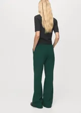 Pantalón de vestir tiro medio color verde oscuro, de corte recto y largo, con trabillas para cinturón y cierre oculto.