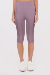 Calza deportiva de largo capri, confeccionada en tejido de poliéster con ajuste al cuerpo y tiro medio.