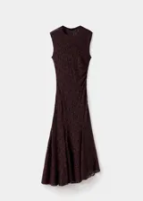 Vestido largo de encaje en color bordó, con diseño entallado, cuello redondo, sin mangas y bajo asimétrico con fruncido lateral. Incluye forro interior.