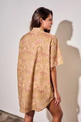 Vestido camisero corto con estampado tipo toile de Jouy a rayas, mangas cortas y cierre frontal con botones.