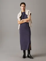 Vestido largo de punto milano color azul con cuello barco y panel trasero recortado.