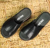 Zuecos de cuero color tostado con textura de reptil, plataforma baja y suela cómoda.