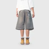 Bermuda de jean estilo baggy con lavado desgastado, corte holgado y largo por debajo de la rodilla. Presenta bordes deshilachados en los bolsillos traseros y en el ruedo, con el logo de la marca bordado en el bolsillo trasero derecho.