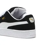 Championes Puma Suede XL negros con detalles en blanco y suela blanca.