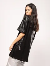 Remera blanca oversized de tela elastizada con tajos laterales y escote redondo.