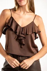 Musculosa de satén color marrón, con escote en V y detalle de volados frontales. Presenta breteles finos y un corte recto.