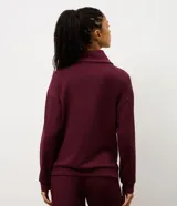 Campera deportiva de modal color bordó, con cierre frontal, cuello alto y puños acanalados. Presenta un diseño entallado con recortes que brindan un ajuste cómodo y moderno.